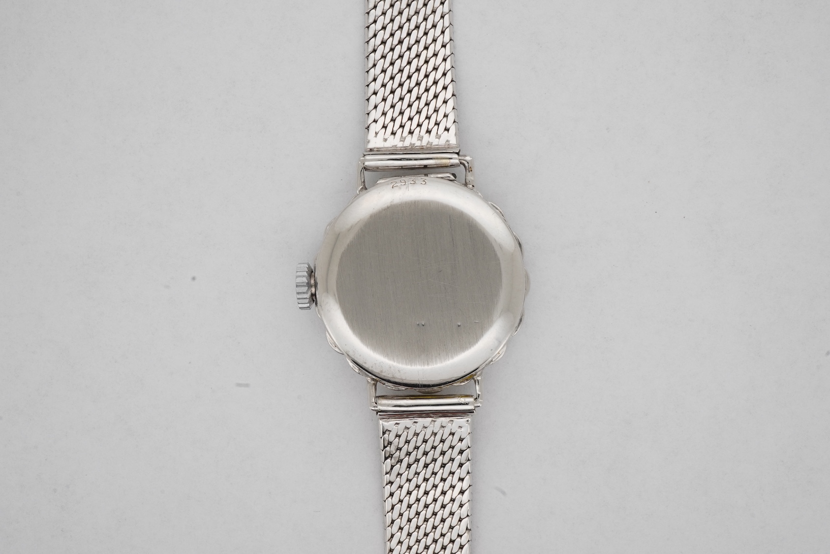 A lady's early 1940's platinum and diamond set manual wind cocktail watch, on a 9ct white gold mesh link bracelet